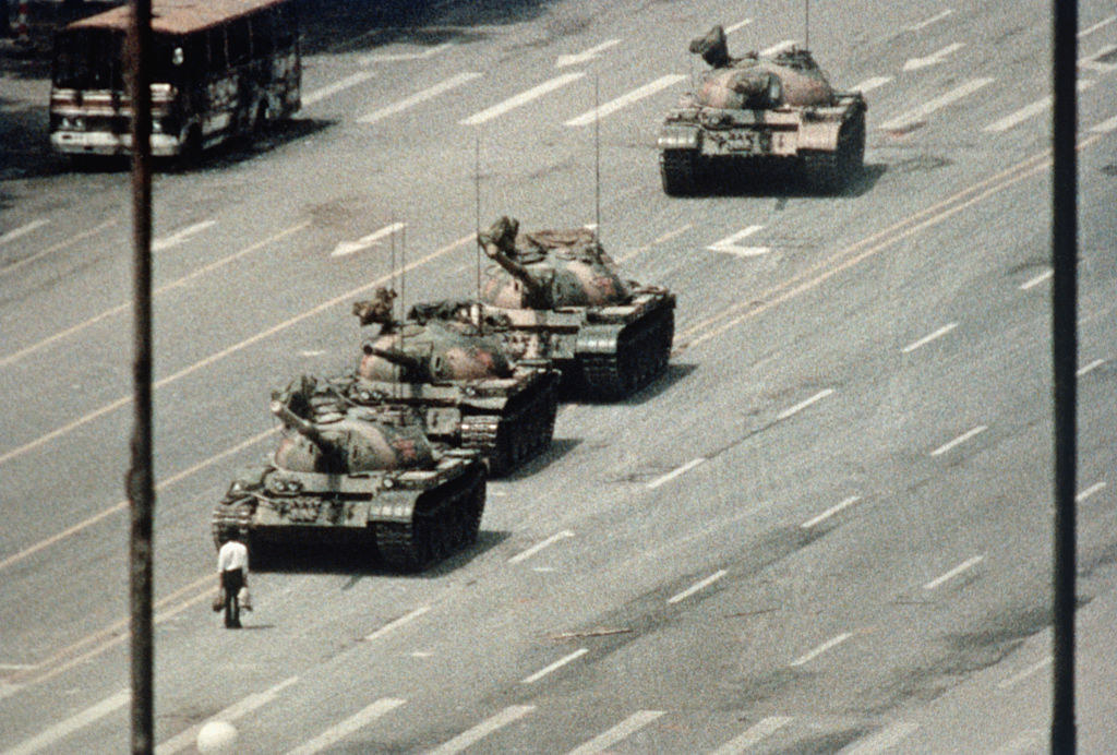 Tank man staring down a line of tanks as he block their path