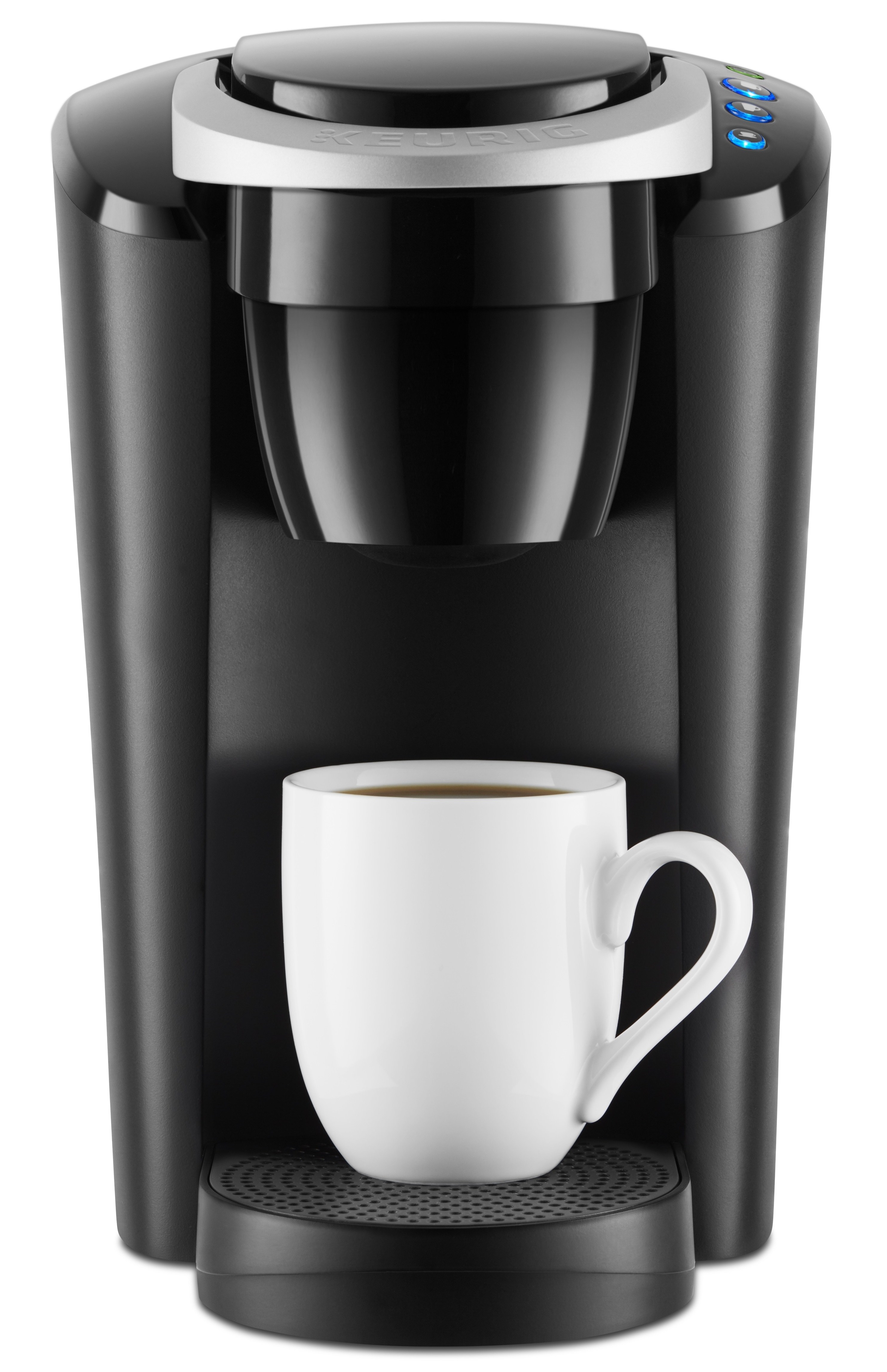 The coffeemaker in black with a white mug in it.