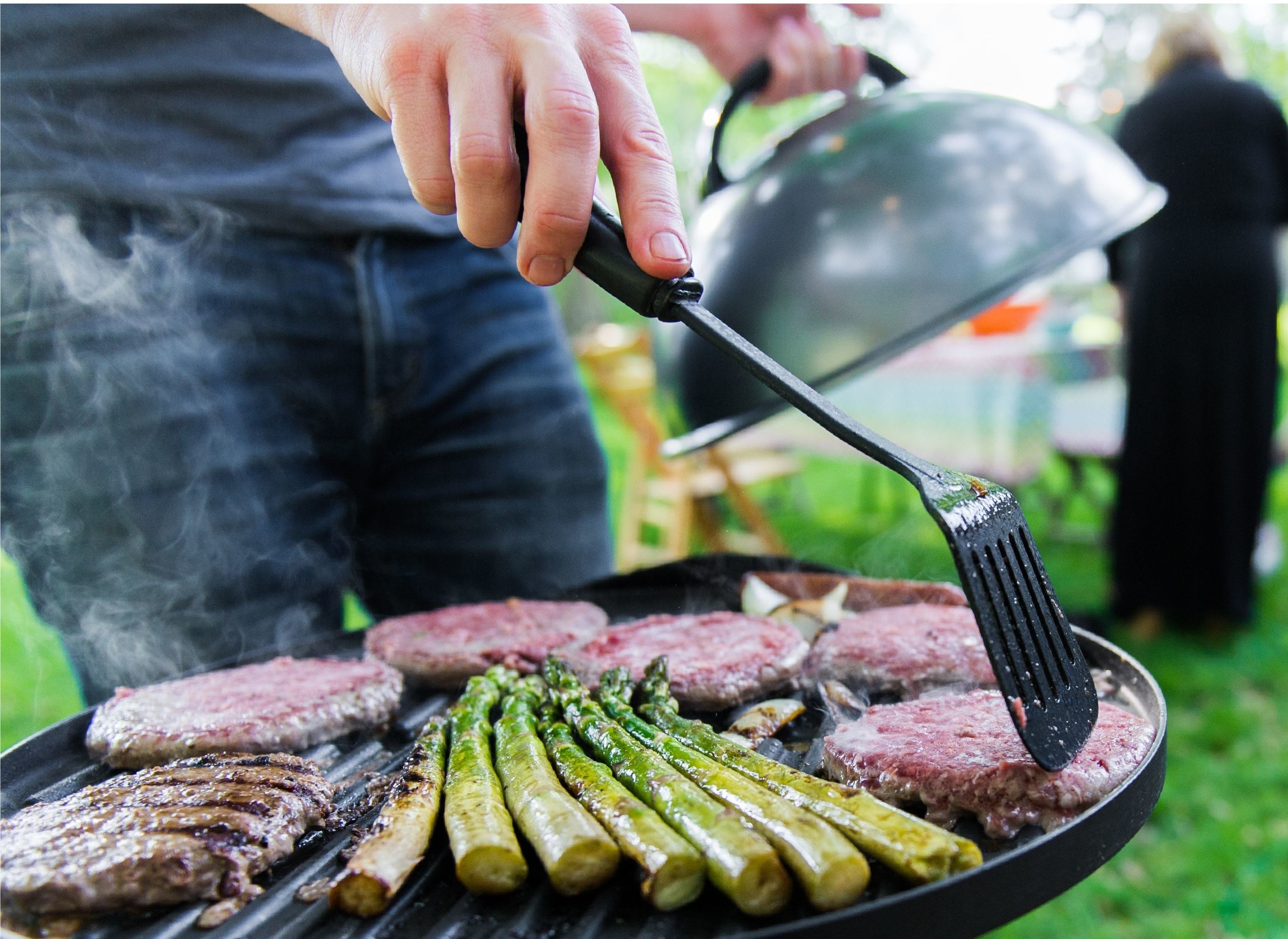 A model uses the grill for burgers and asparagus