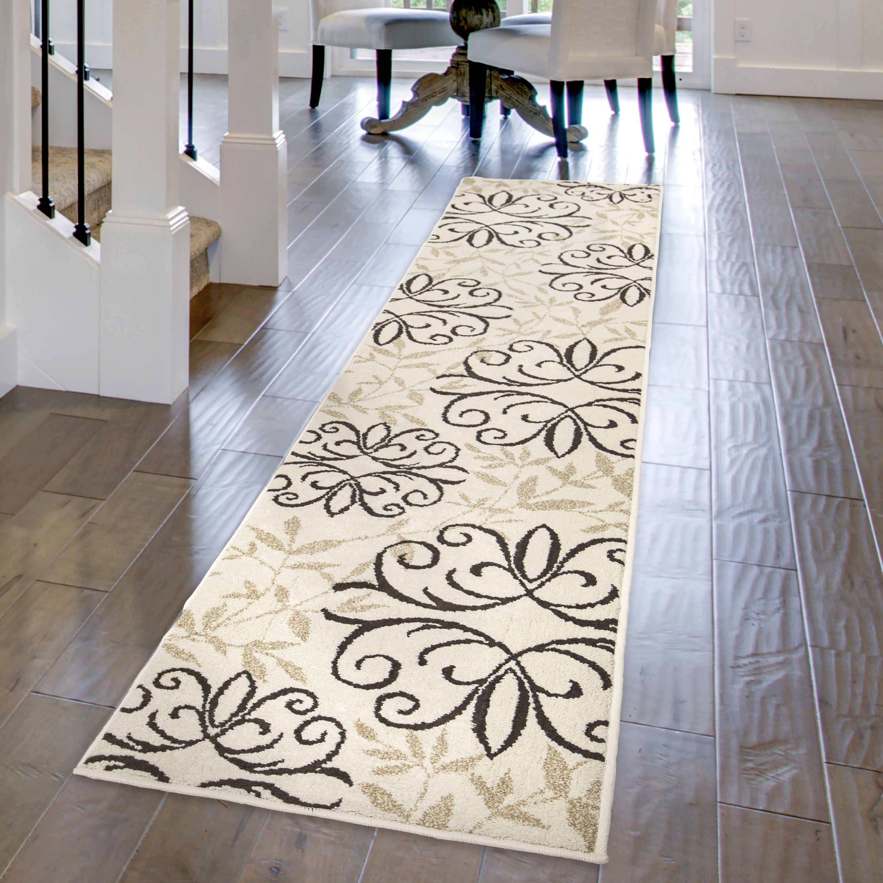 The taupe and brown rug in runner-size