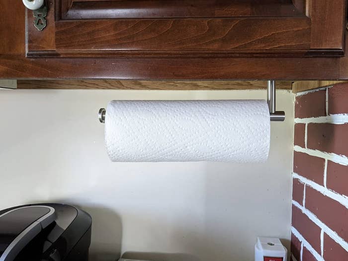 Paper towel holder mounted under kitchen cabinet