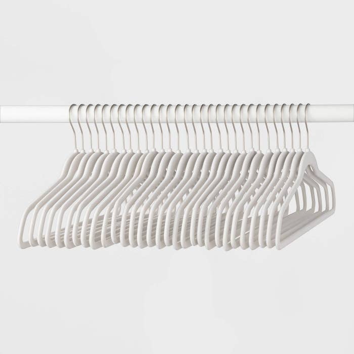 A set of white suit hangers hanging
