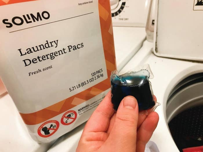 reviewer photo of the laundry pods on top of their washing machine