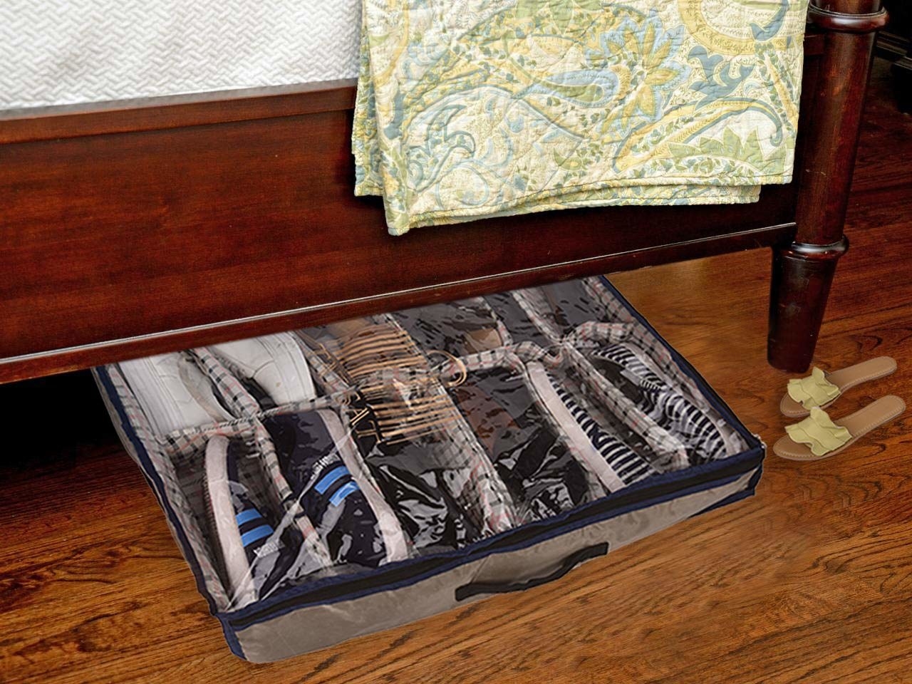 A shoe organiser with shoes in it under a bed 