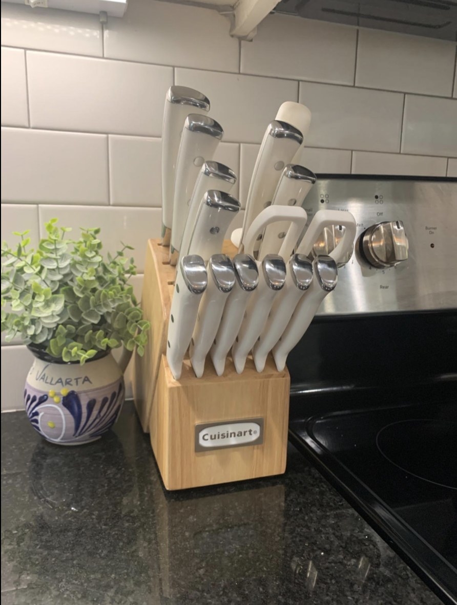 the knife block holding various knifes and a pair of scissors