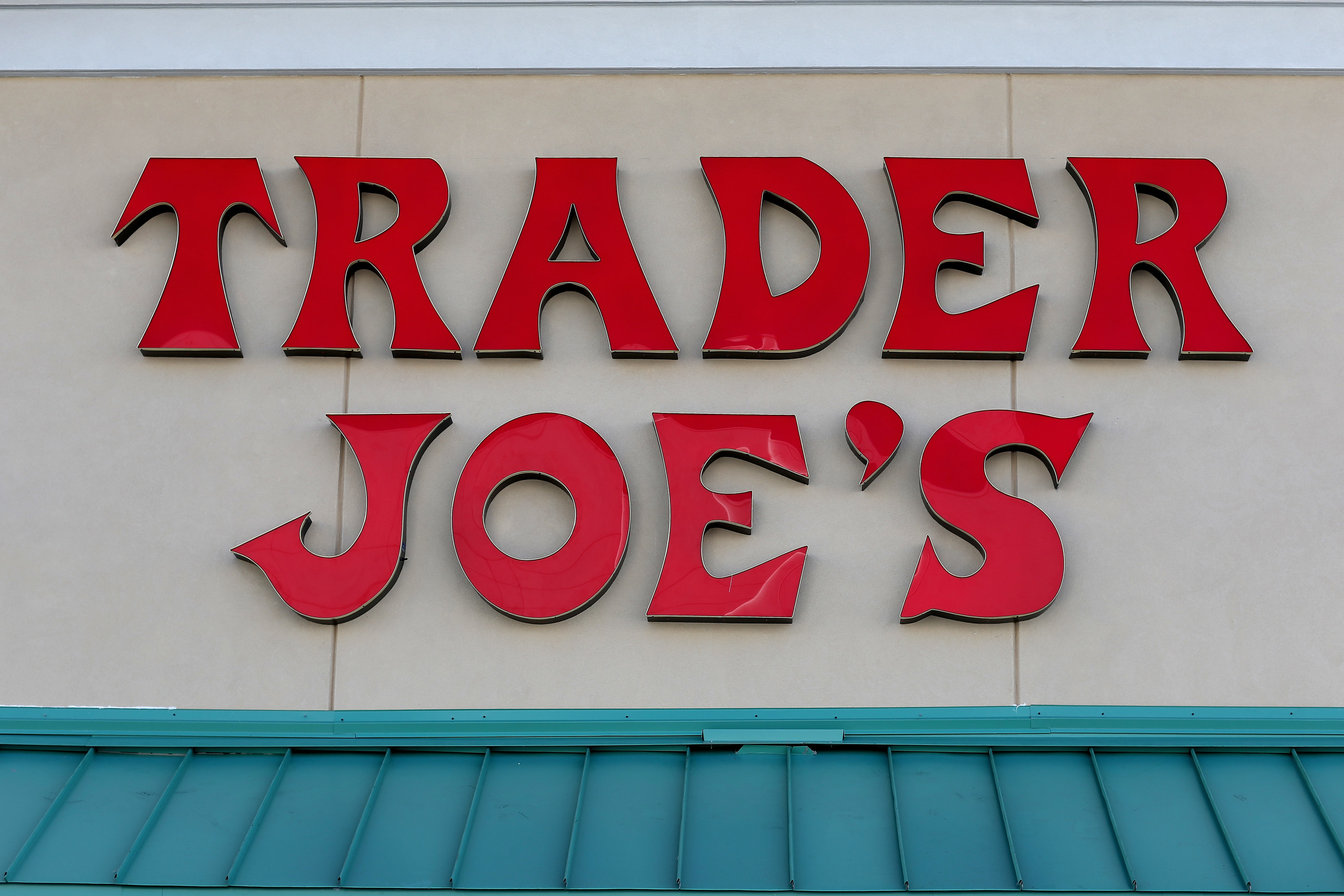 Red Trader Joe&#x27;s sign in front of store.