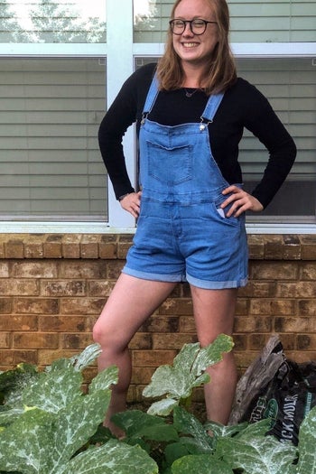 Reviewer wearing overall shorts