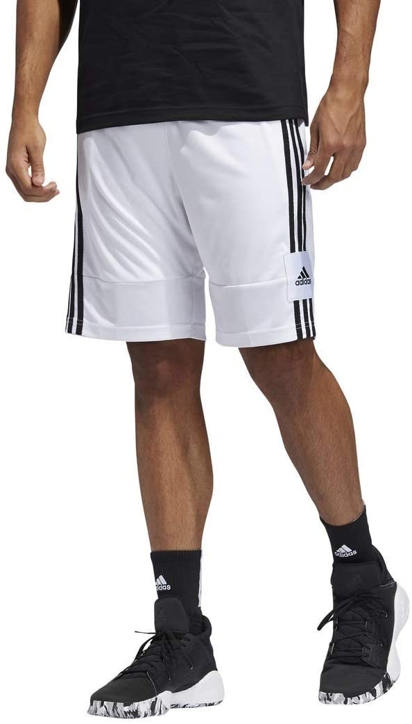 model wearing white shorts with black side stripes