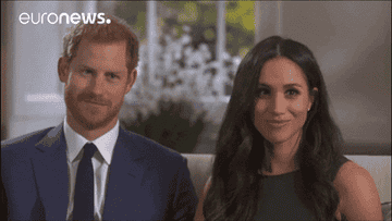 Prince Harry and Meghan Markle look at one another and smile