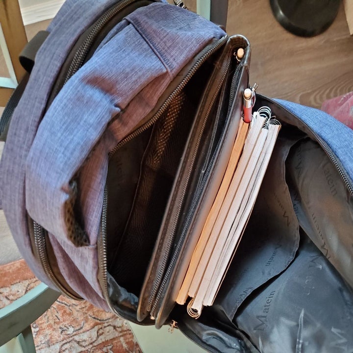 a reviewer photo of the open backpack with notebooks inside 