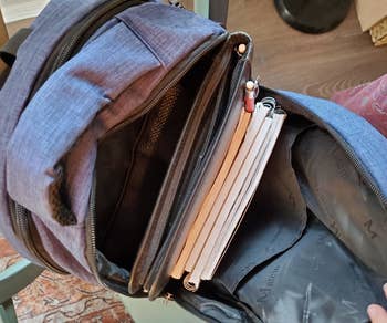 a reviewer photo of the open backpack with notebooks inside 