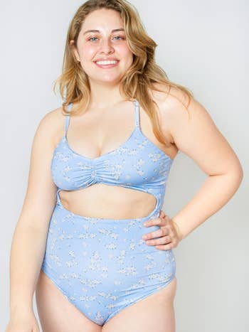 a plus size model wearing the cut out one piece in the willow pattern