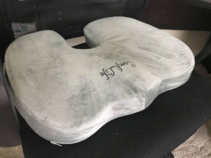a reviewer photo of the cushion on a black desk chair 