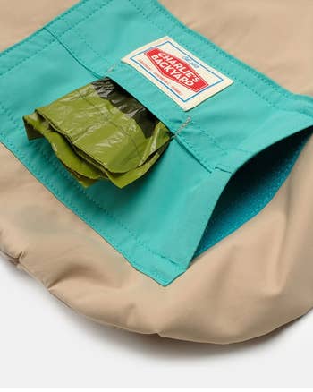 close-up shot of a pocket on a dog windbreaker showing how it can hold poop bags