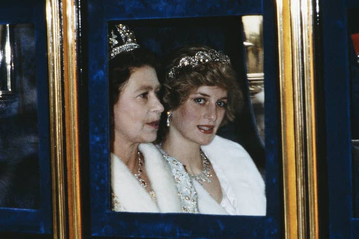 The Princess of Wales and the Queen sitting in a carriage while wearing tiaras as they attend the Opening of Parliament in London, November 1982