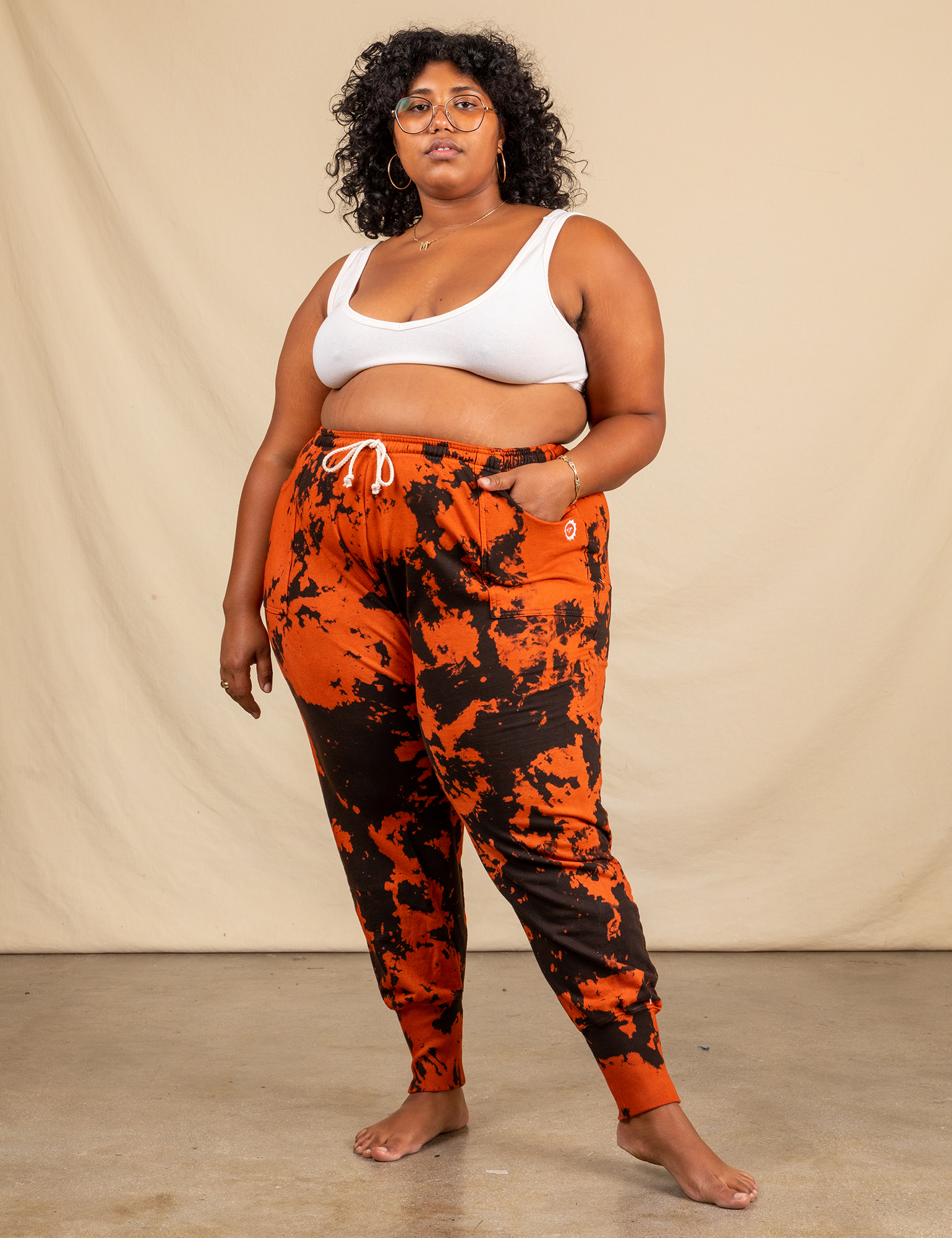 Model wearing orange and black sweatpants