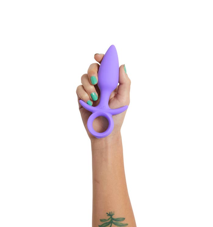 Purple silicone tapered anal plug with finger loop base
