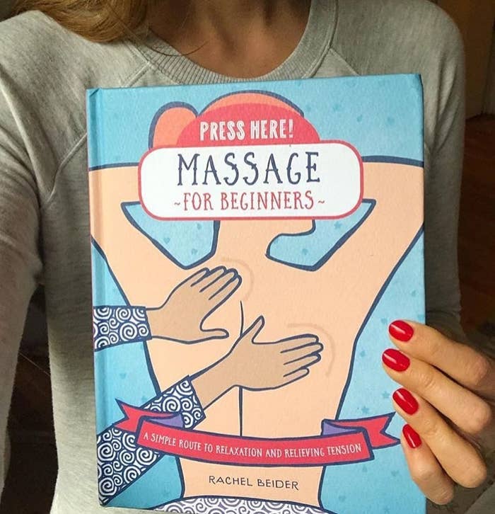 A person holding up the massage guide for beginners