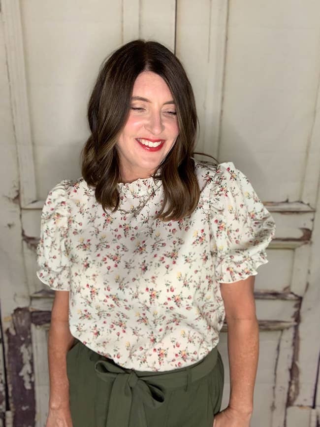 Reviewer wearing floral print ruffle top