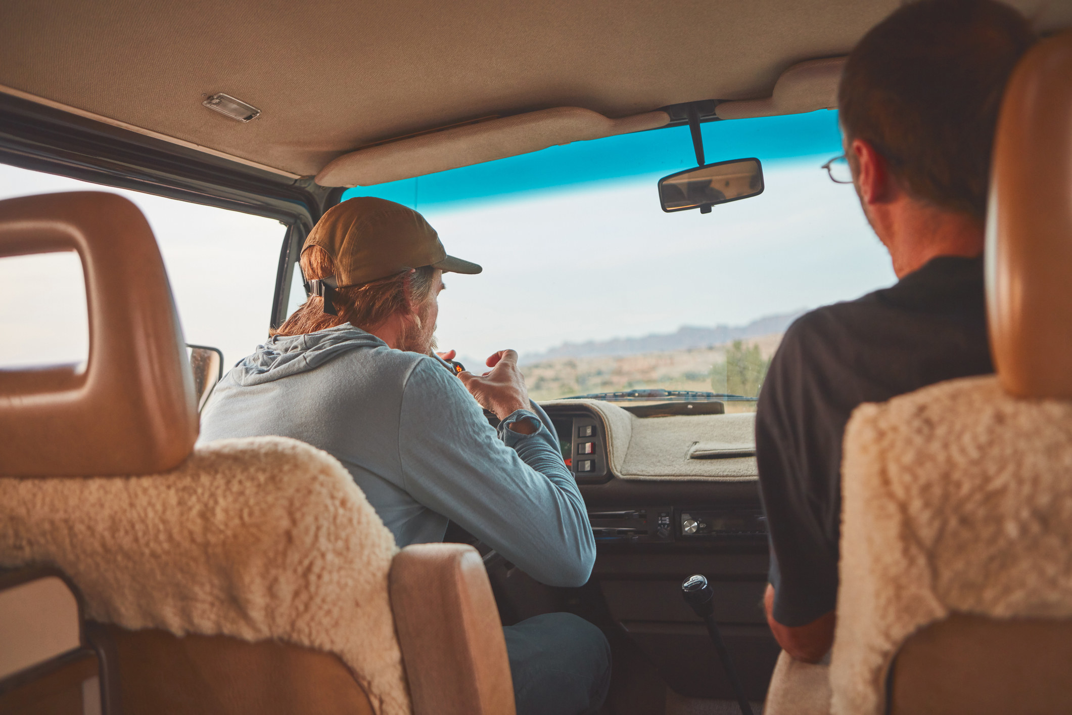 man smoking with friend in a van