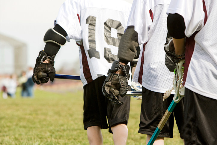 teenagers playing lacrosse