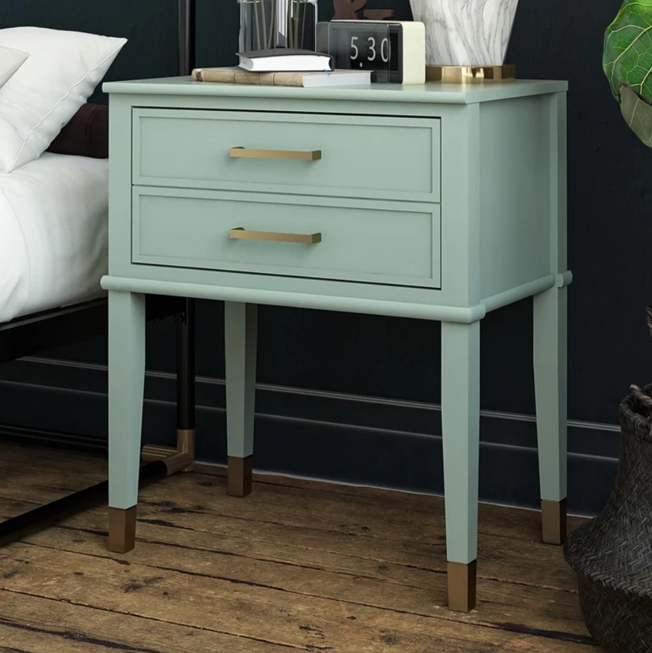A bleached teal nightstand with two drawers next to a bed