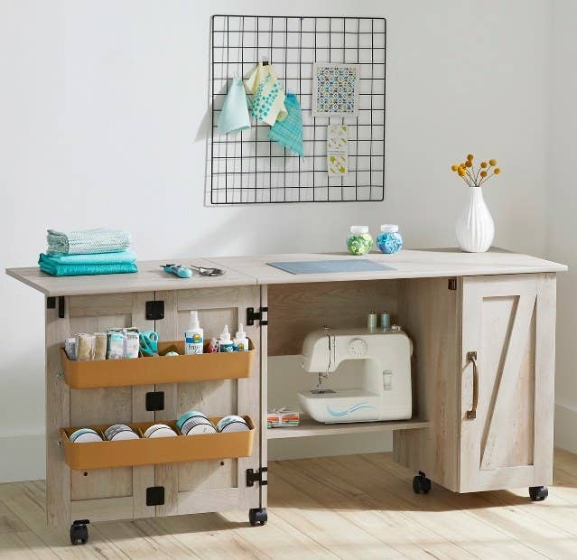 an open sewing table in a craft room