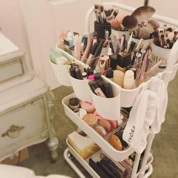 reviewer's large amount of makeup stored on a rolling cart