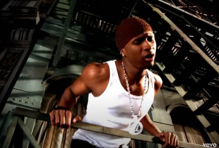 Screenshot of Usher singing on a fire escape wearing a white tank