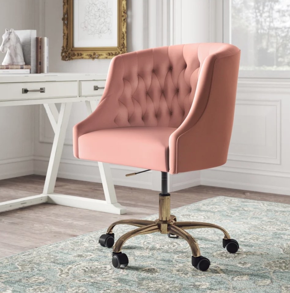 A pink, padded office chair with a swivel base on five wheels