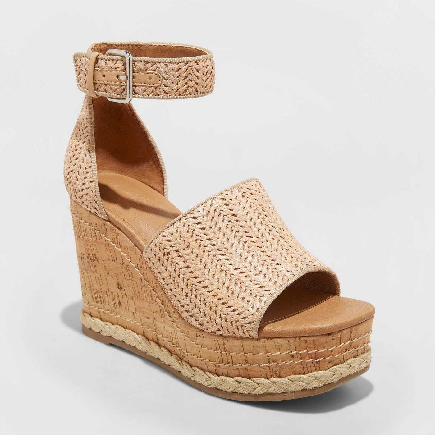 Wedges with braided detailing and stitching on sole, tan colored straps and camel sole