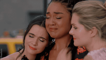 Gif of Kat, Jane, and Sutton hugging each other