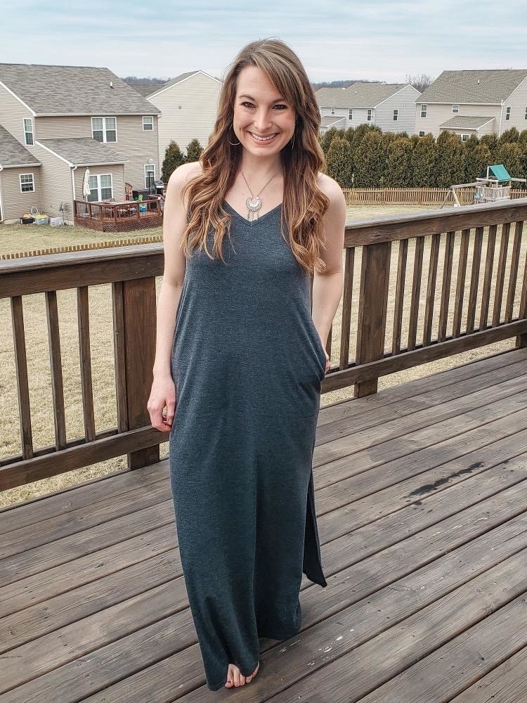 image of reviewer wearing the dark grey maxi dress in a large, standing on a porch
