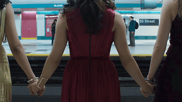 Gif of the girls holding hands