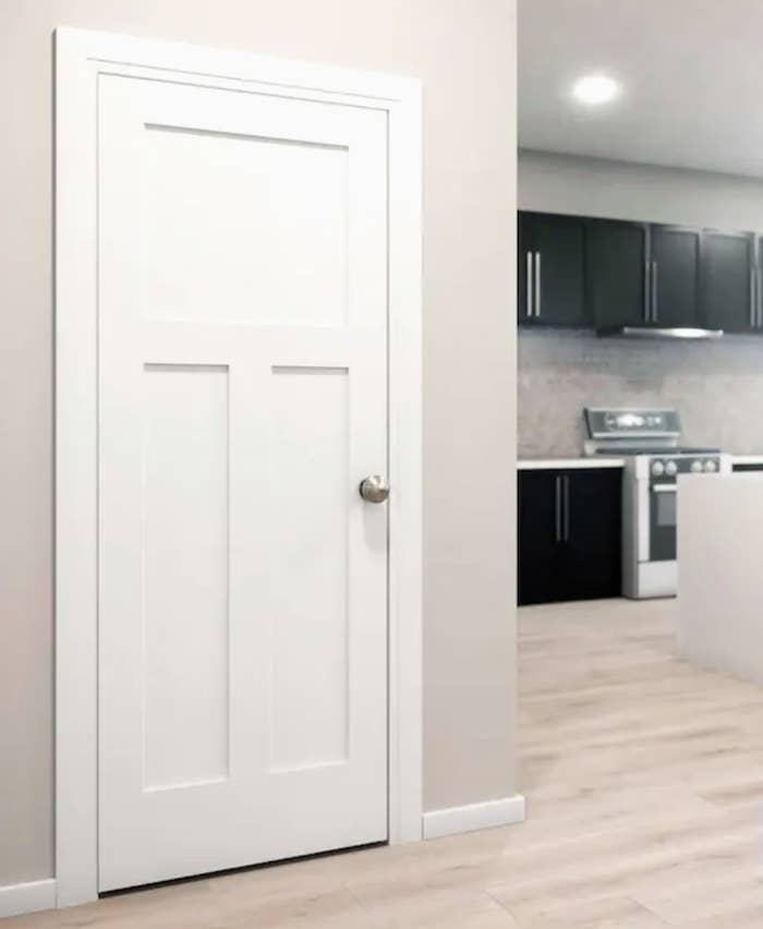 An interior solid core door leading to a kitchen