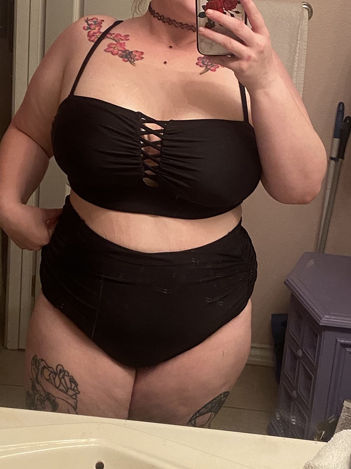 image of plus size reviewer wearing the black retro two piece in XL