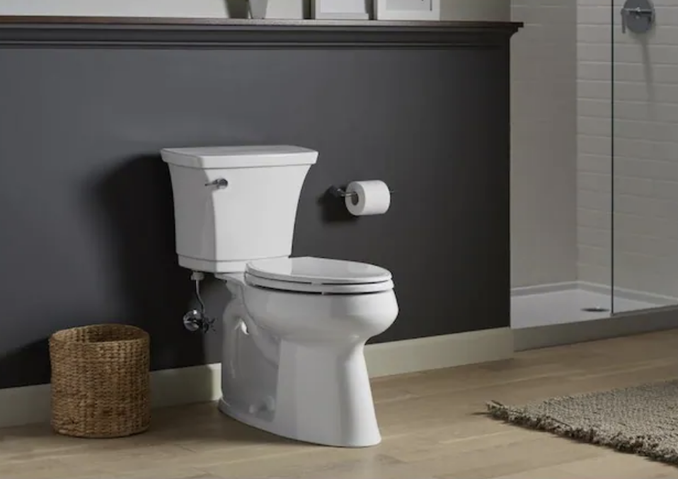 A bathroom with a tall ADA-compliant toilet