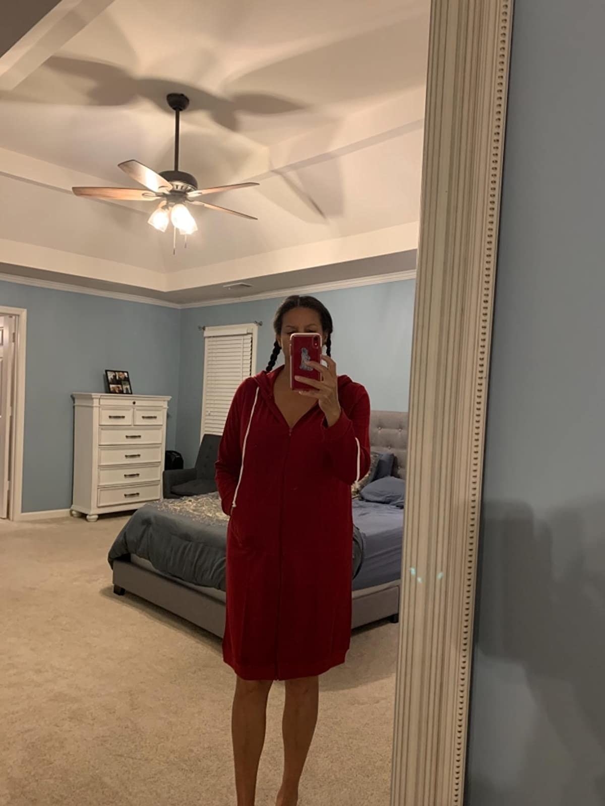 image of reviewer taking a mirror selfie wearing the wine red hoodie tunic
