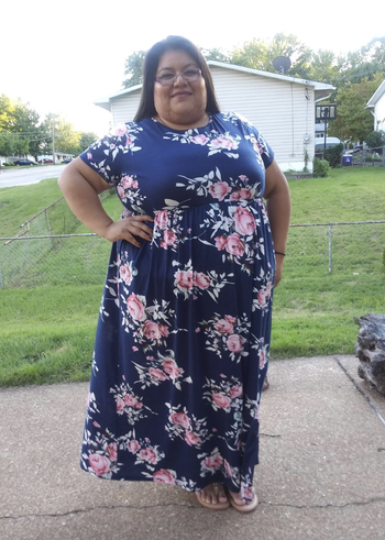 reviewer wearing a floral dress 