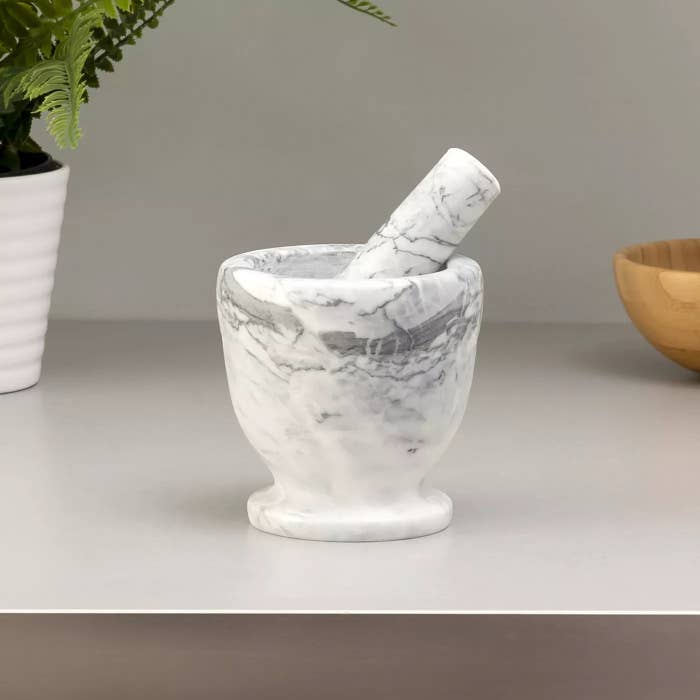 The mortar and pestle in white marble