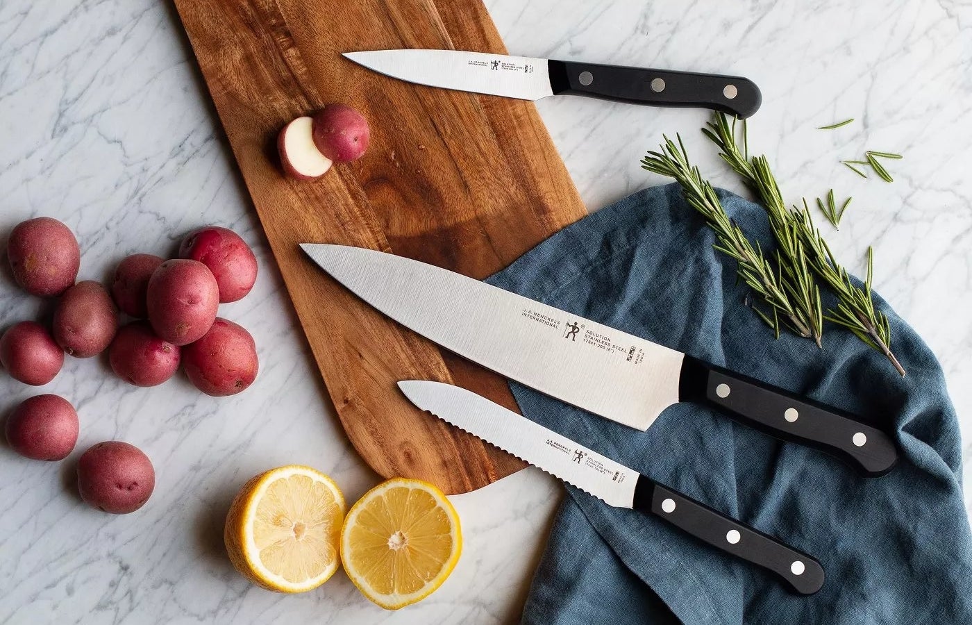 A chef knife, a bread knife, and a paring knife