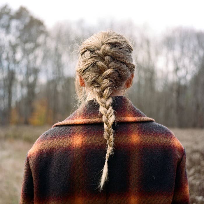 taylor swift faces away from the camera, hair in a long braid