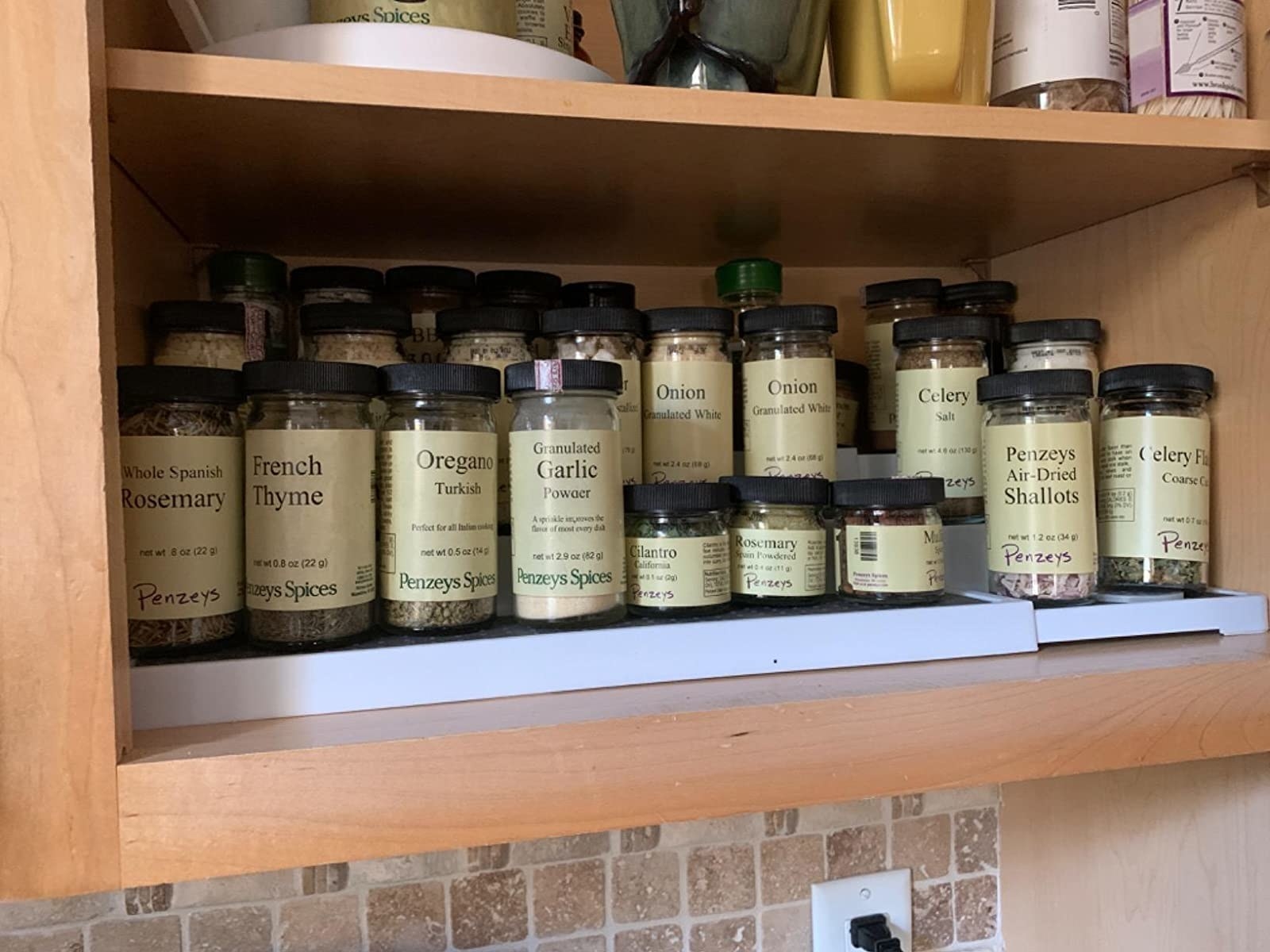 reviewer&#x27;s spice cabinet organized with a three-tier spice rack