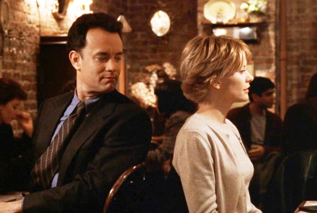 Tom hanks staring at his love interest while at dinner