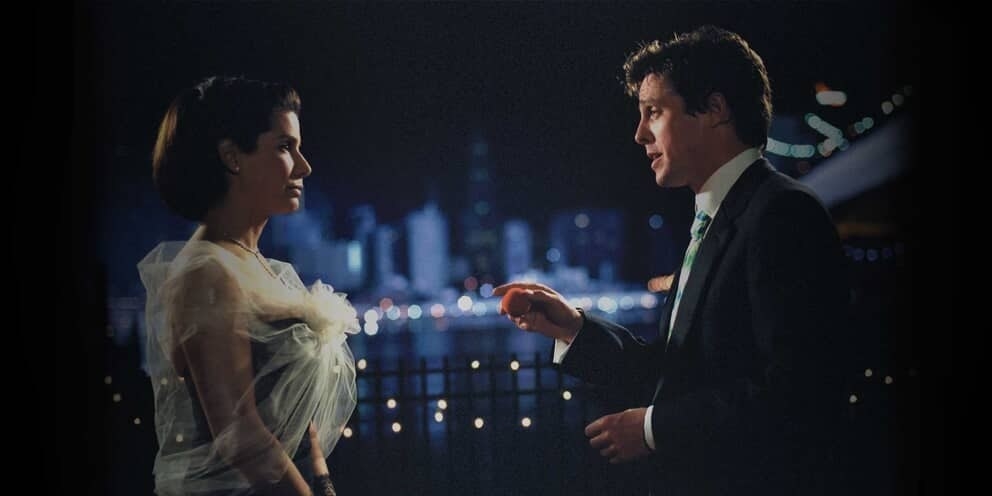 the leads of the film having an intimate discussion with the new york city skylight in the background 