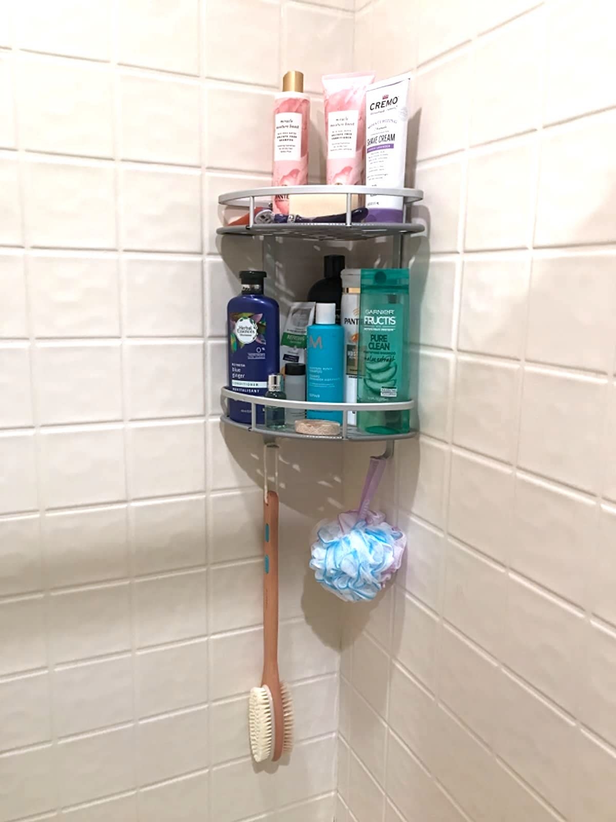 reviewer photo of a shower caddy in the corner of a shower