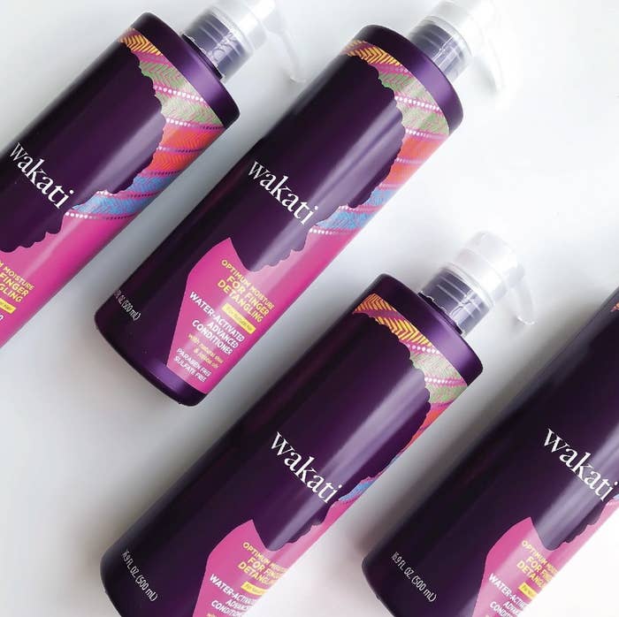 A set of purple bottles with hair conditioner