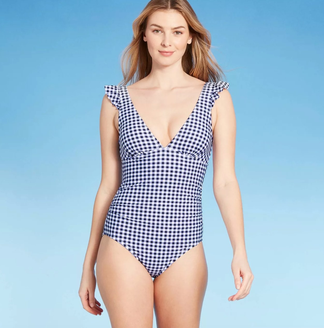model wearing the white and blue gingham suit
