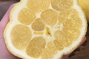 A lemon with many sections in the middle that look like holes