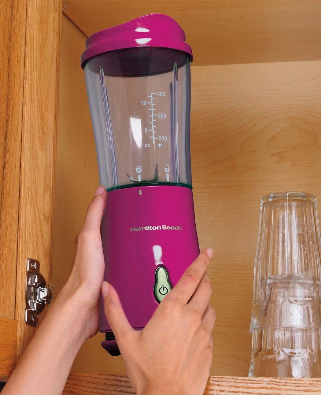 Model holding the personal blender in pink